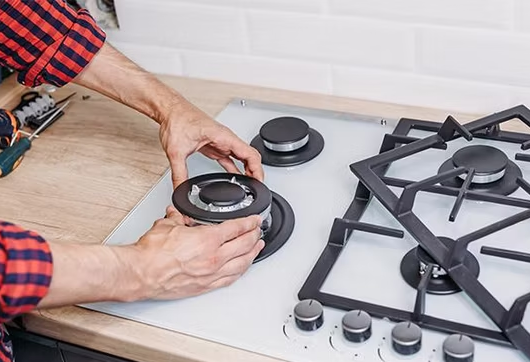 A Men Fix The Gas Cooker